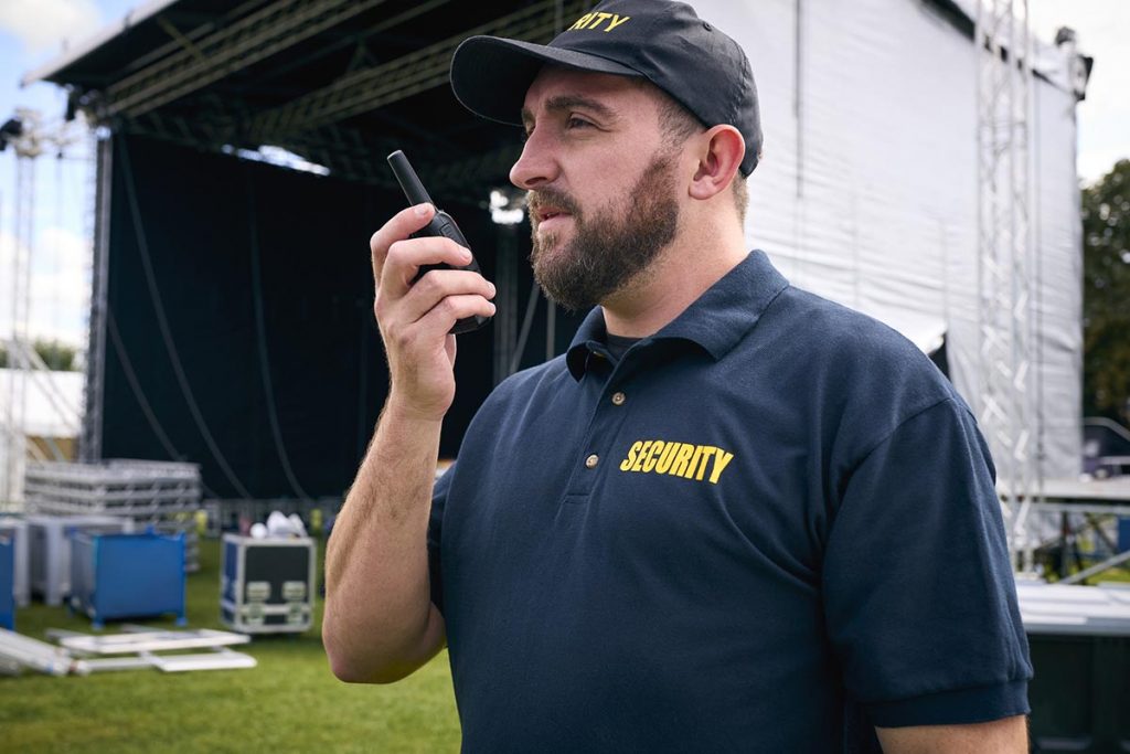 event security guard speaking on walkie talkie