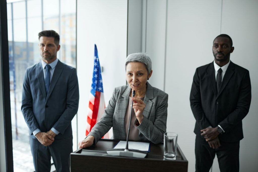 Executive Protection Agents Protecting an Executive Woman Giving a Presentation