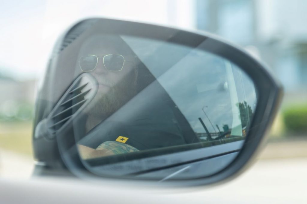 Convoy Group Executive Protection Agent Conducting Mobile Physical Surveillance from a Vehicle