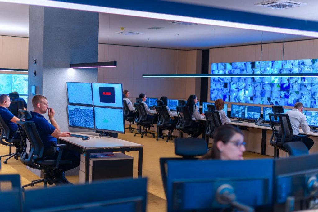 Business professional reviewing insider threat alert on desktop security dashboard