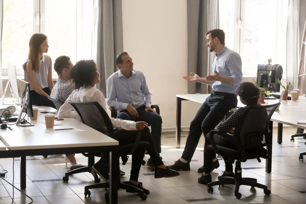 Team discussing behavioral indicators and workplace dynamics related to insider threat awareness and prevention